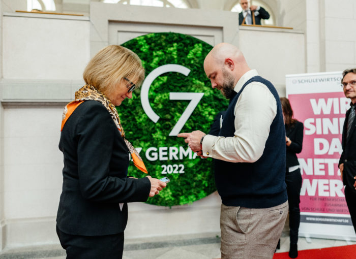 Teilnehmer bei der Verleihung vom Schulewirtschaft Preis tauschen Kontaktdaten aus